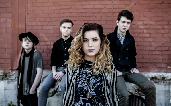 HD desktop wallpaper of Echosmith with Sydney Sierota at the front, posing in front of a red brick wall.