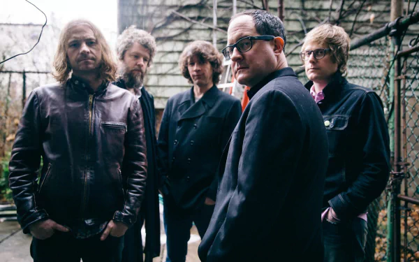 HD desktop wallpaper featuring the band The Hold Steady posing thoughtfully in an urban outdoor setting.