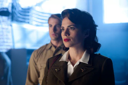 4K Ultra HD PC desktop wallpaper: Peggy Carter in WWII military uniform foreground, Captain America (Steve Rogers) blurred behind — scene from Captain America: The First Avenger.