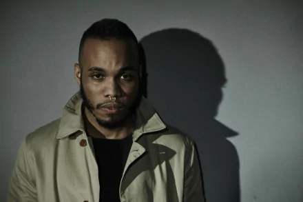 HD wallpaper featuring a moody portrait of a man with a shadow profile, tagged with Anderson .Paak.