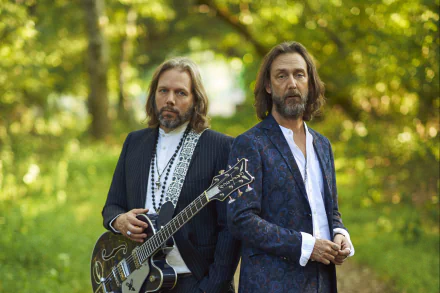 HD desktop wallpaper of The Black Crowes members standing outdoors with a guitar.