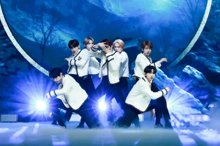 ENHYPEN members performing on stage with a dynamic blue backdrop for an HD desktop wallpaper.