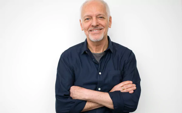 HD desktop wallpaper featuring a smiling man with his arms crossed against a white background.
