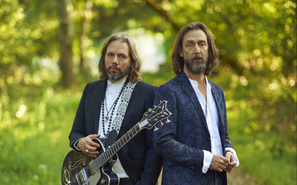 HD desktop wallpaper of The Black Crowes members standing outdoors with a guitar.