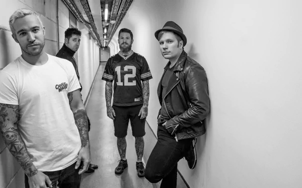 Black and white HD wallpaper featuring the members of Fall Out Boy posing in a hallway for a desktop background.