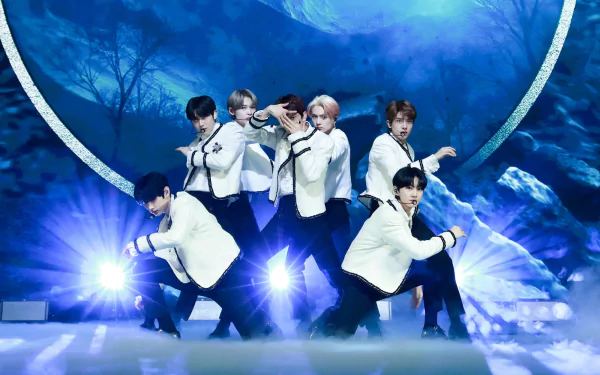 ENHYPEN members performing on stage with a dynamic blue backdrop for an HD desktop wallpaper.