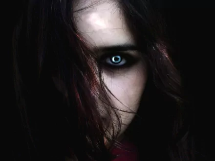 HD fantasy wallpaper featuring a vampire with dark hair and a piercing eye illuminated against a black background.