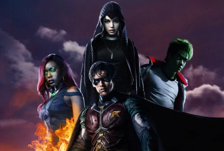 HD Titans TV wallpaper: hooded Raven above front‑center Robin (Dick Grayson), Beast Boy (Garfield Logan) with green skin at right, and Starfire flaming at left.