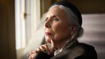 HD desktop wallpaper featuring a pensive woman with silver hair looking out the window, tagged as a background image inspired by Joni Mitchell.
