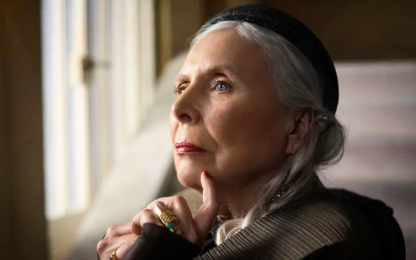 HD desktop wallpaper featuring a pensive woman with silver hair looking out the window, tagged as a background image inspired by Joni Mitchell.
