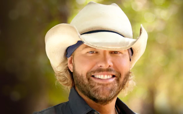 Smiling man in a cowboy hat posing for an HD desktop wallpaper and background.