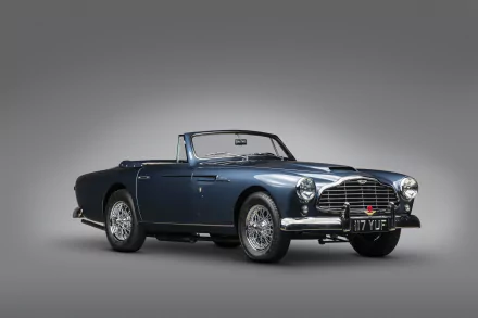Blue Aston Martin DB2 convertible viewed front-side on a neutral gray background, rendered as a 4K Ultra HD PC desktop wallpaper.
