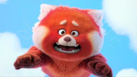 HD PC desktop wallpaper and background: the red panda from the movie Turning Red reaches toward the viewer with a startled expression against a bright blue sky.