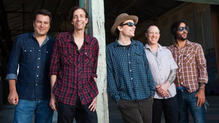 HD desktop wallpaper featuring The Wallflowers band members smiling in casual attire as a stylish background.