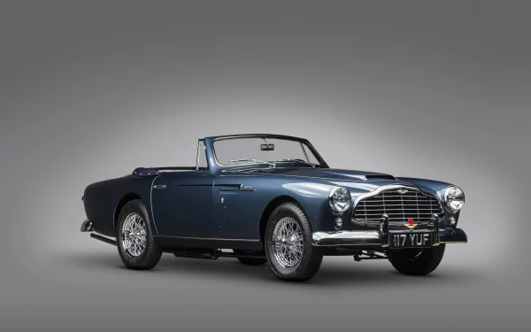 Blue Aston Martin DB2 convertible viewed front-side on a neutral gray background, rendered as a 4K Ultra HD PC desktop wallpaper.
