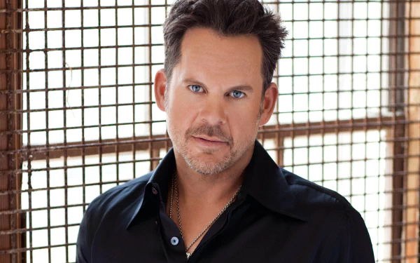 HD desktop wallpaper featuring a man with stylish hair and a black shirt, suitable as a professional background or screen decor.