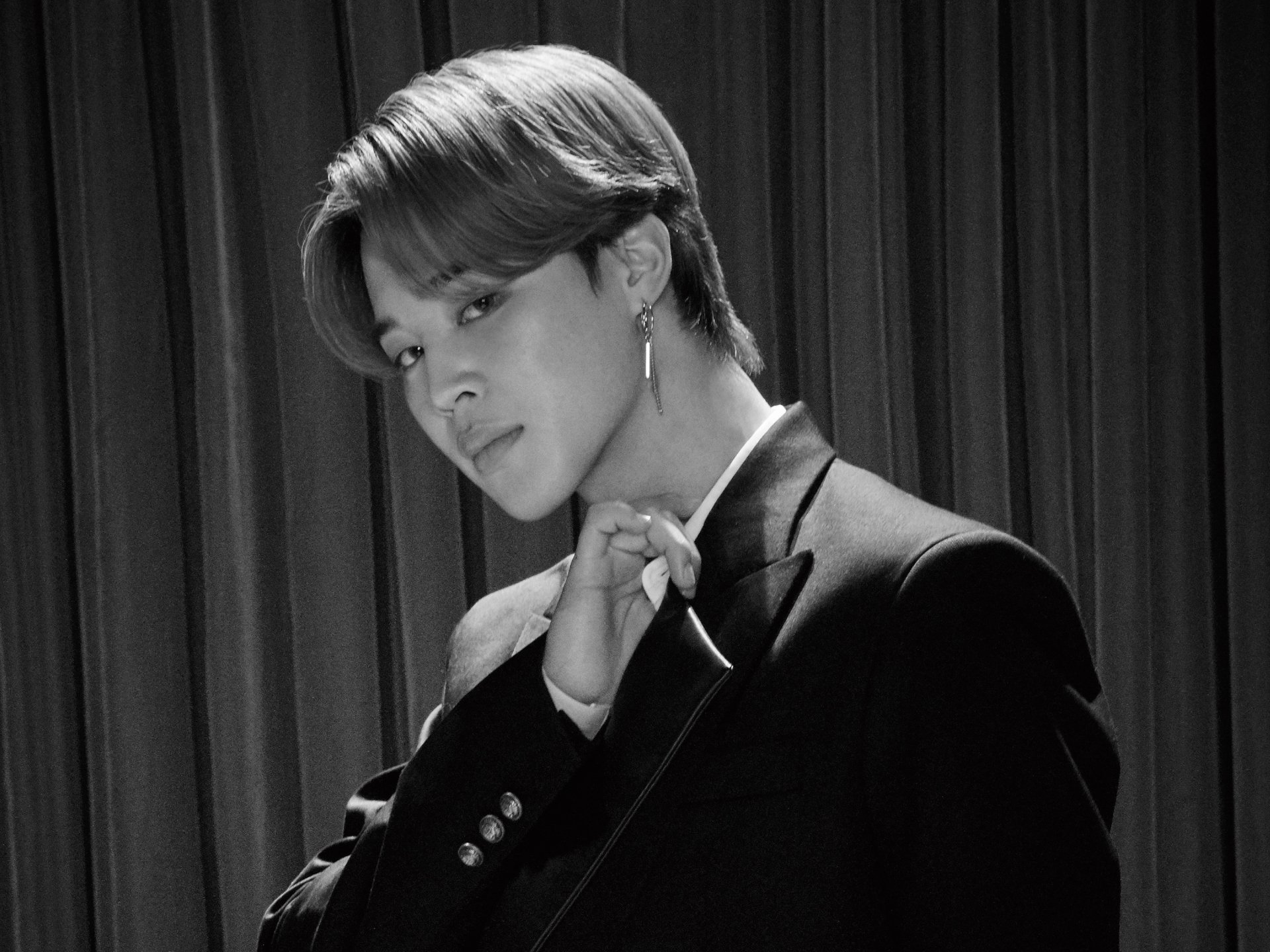 Black-and-white HD desktop wallpaper featuring Jimin from BTS, a K-pop singer, posing stylishly against a curtain backdrop.