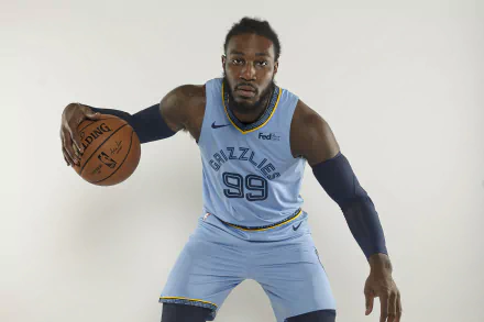 Jae Crowder in a blue Memphis Grizzlies uniform poses with a basketball. This HD desktop wallpaper captures the essence of sports and athleticism.