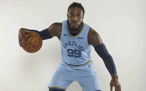 Jae Crowder in a blue Memphis Grizzlies uniform poses with a basketball. This HD desktop wallpaper captures the essence of sports and athleticism.