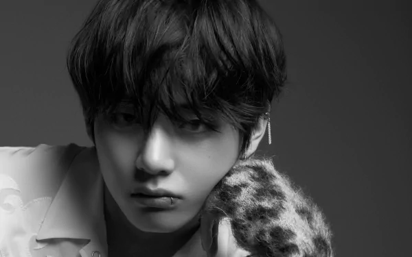 Grayscale close-up of a K-pop singer and music artist with tousled hair and an earring, moody expression — 2K Quad HD PC desktop wallpaper.