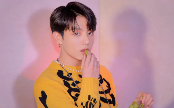 4K Ultra HD image of Jungkook, BTS singer, posing against a pastel background, showcasing K-pop style and music influence.