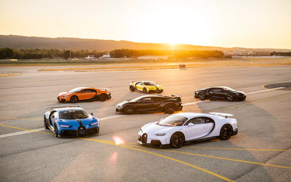 Group of Bugatti Chiron supercar vehicles on an airstrip at sunrise, vivid colors and reflections — 8K Ultra HD PC desktop wallpaper/background.