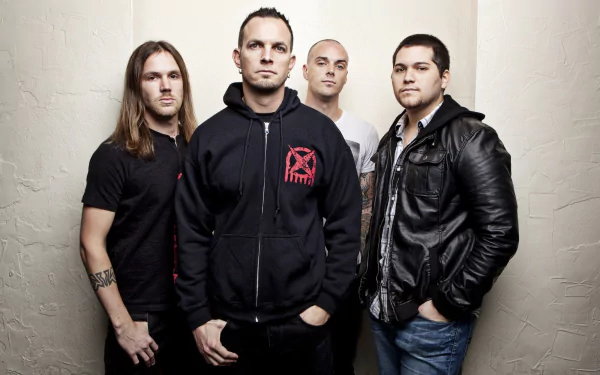 A striking HD desktop wallpaper featuring the band Tremonti, showcasing four members in a studio setting, exuding a powerful and intense music vibe.