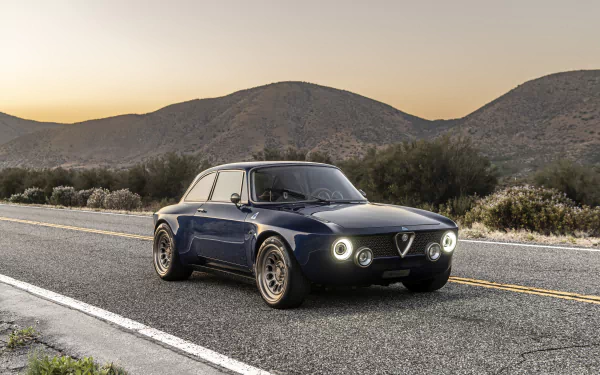 8K Ultra HD PC desktop wallpaper of a Totem Automobili GT Electric — navy electric car parked on a scenic highway at sunset with rolling hills.