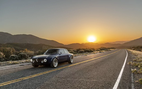 Totem Automobili GT Electric vehicle on a desert highway at sunset with mountains in the distance — 8K Ultra HD PC desktop wallpaper.