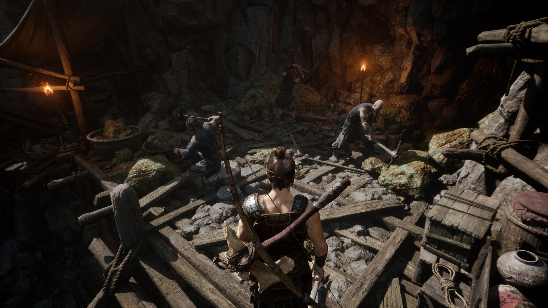 HD wallpaper of a scene from Myth of Empires game showcasing a character inside a dimly lit mining cave with figures working in the background.