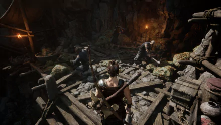 HD wallpaper of a scene from Myth of Empires game showcasing a character inside a dimly lit mining cave with figures working in the background.