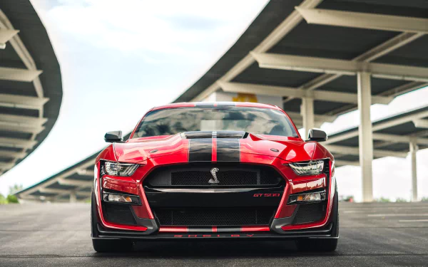 Red Ford Mustang Shelby GT500 muscle car, front view under an overpass — HD PC desktop wallpaper and background.