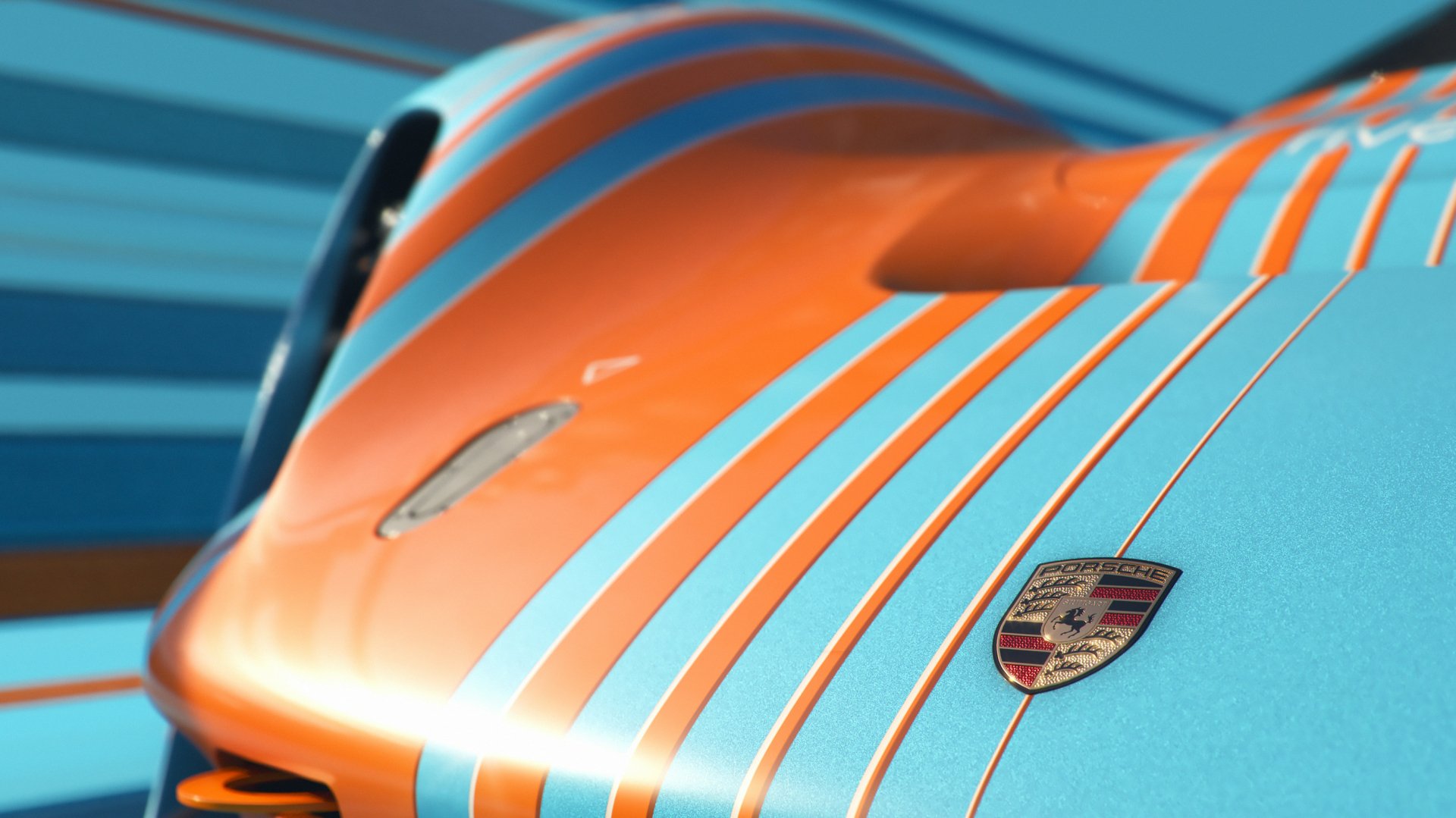 Close-up of the Porsche Vision 908, showcasing its striking blue and orange stripes. This HD wallpaper features dynamic lines highlighting the vehicle's sleek design.