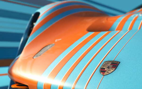 Close-up of the Porsche Vision 908, showcasing its striking blue and orange stripes. This HD wallpaper features dynamic lines highlighting the vehicle's sleek design.