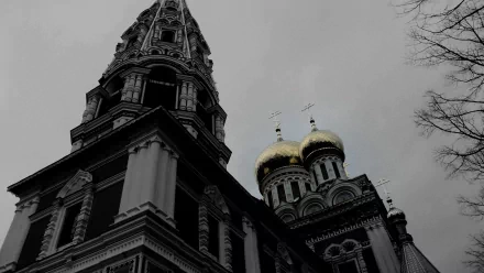 A dramatic black and white 4K Ultra HD image of a historic church with ornate domes and spires, showcasing intricate man-made architecture against a cloudy sky.