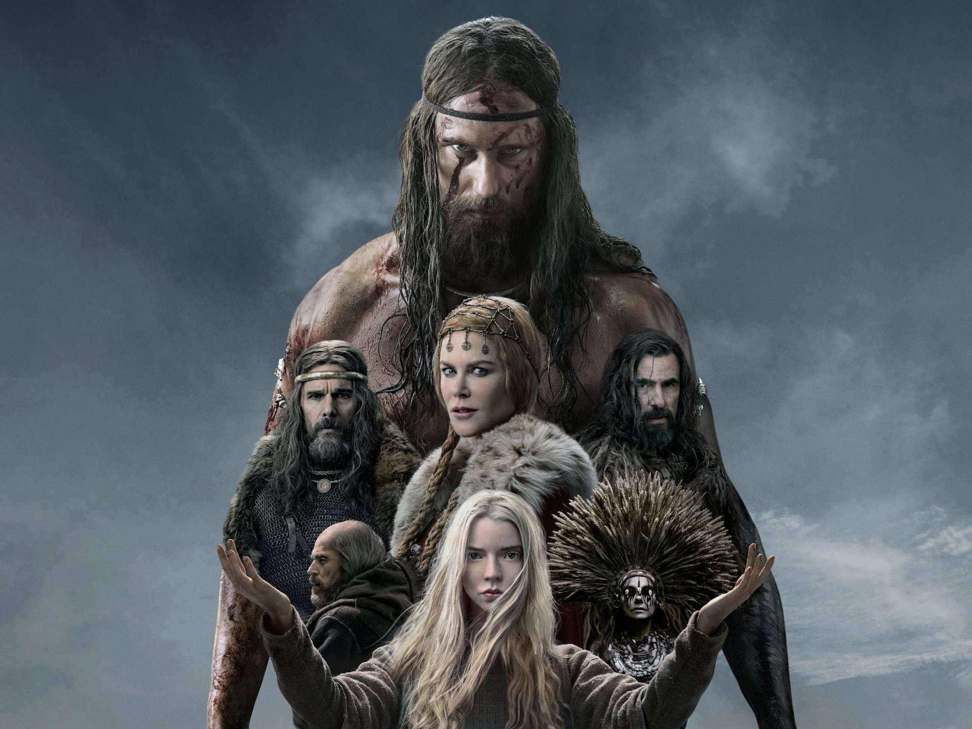5K Ultra HD PC desktop wallpaper for the movie The Northman: a brooding, bearded warrior looms behind costumed cast in fur and armor under stormy skies.