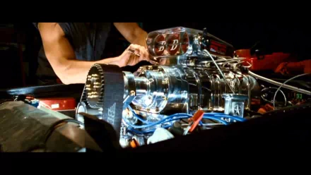 A HD desktop wallpaper featuring a detailed shot of a car engine being worked on, from the Fast & Furious movie series.