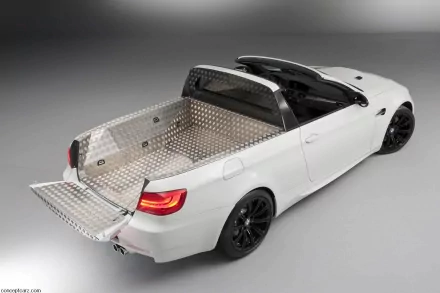 White BMW vehicle converted to a pickup with diamond-plate cargo bed and open tailgate, black wheels and glowing red taillights on a neutral studio floor — HD PC desktop wallpaper and background.