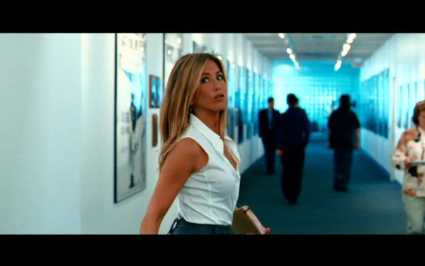 Jennifer Aniston stars in the movie The Bounty Hunter, captured in this HD desktop wallpaper as she walks through a stylish corridor, showcasing her elegance and intensity.