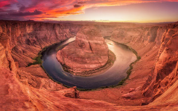 HD PC desktop wallpaper showing the natural beauty of Horseshoe Bend, a dramatic canyon with a winding river under a vibrant sunset sky.