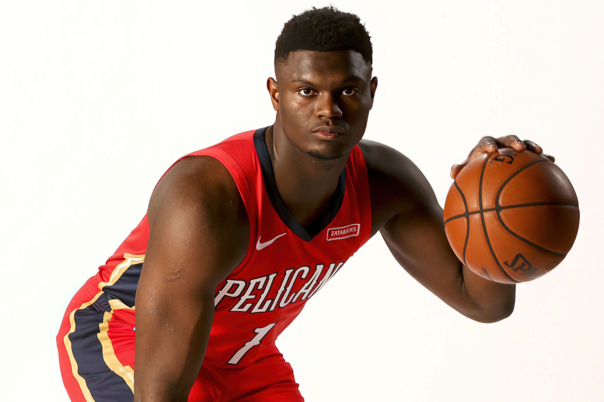Zion Williamson poses confidently in his New Orleans Pelicans jersey, ready to make a play. This striking HD wallpaper captures his athletic spirit perfectly.