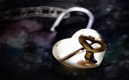 A heart-shaped padlock with a chain, symbolizing love and connection, set against a soft, blurred background. This HD image makes a captivating desktop wallpaper.