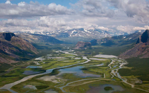 Aerial view of the Rapa River winding through a lush valley in Sarek National Park, an expansive nature panorama — 5K Ultra HD PC desktop wallpaper and background.