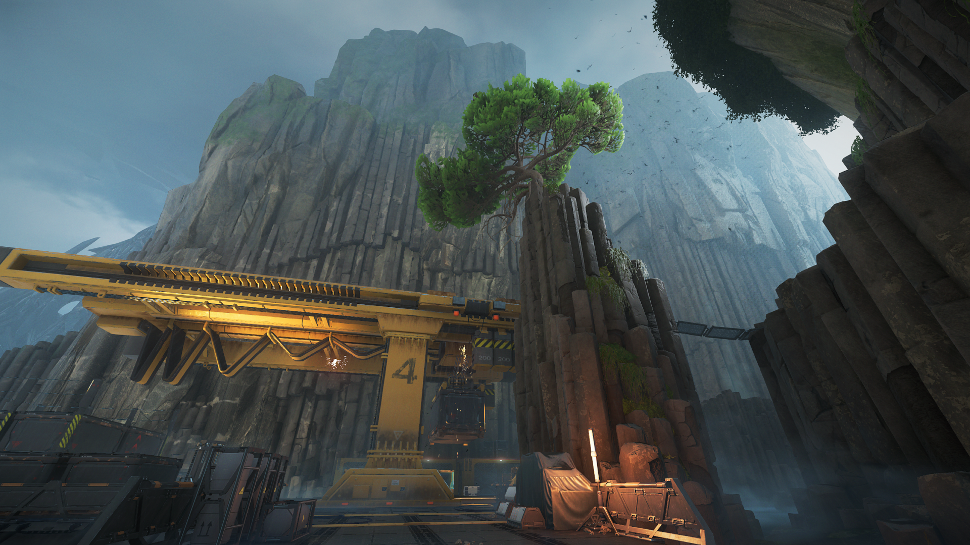 A scenic Shatterline HD desktop wallpaper featuring towering cliffs, a solitary tree on rock outcrop, and industrial elements against a serene sky background.