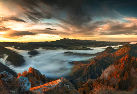 HD PC desktop wallpaper and background: panoramic nature landscape of mountain peaks and autumn forests emerging from a sea of clouds beneath a dramatic sunset sky.