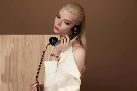 4K Ultra HD desktop wallpaper featuring celebrity Anya Taylor-Joy in a stylish white outfit holding a vintage telephone against a brown background.