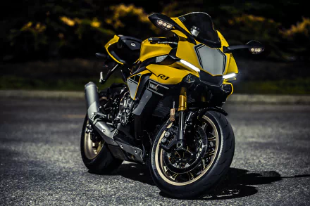 A sleek yellow Yamaha YZF-R1 motorcycle parked on asphalt, captured in sharp 4K Ultra HD, making a dynamic PC desktop wallpaper and background.