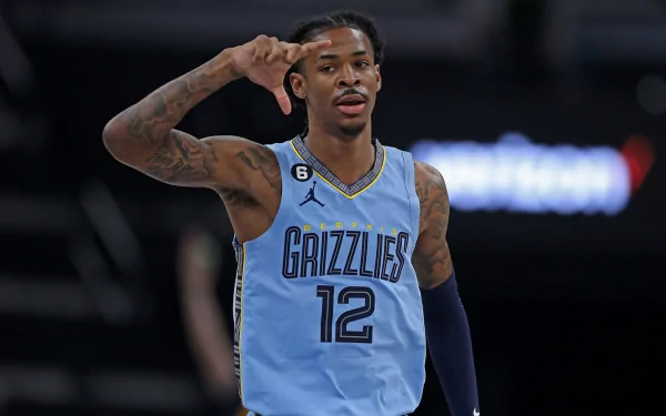 Memphis Grizzlies point guard Ja Morant in action, set against a vibrant background in this HD desktop wallpaper.