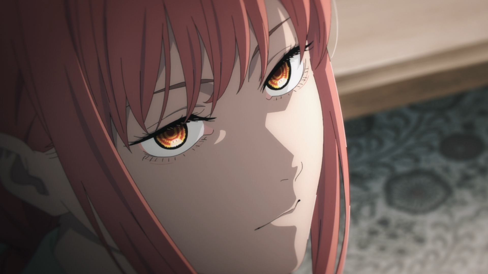 Close-up of Makima from Chainsaw Man anime, featuring her orange eyes and red hair in an HD PC desktop wallpaper and background.