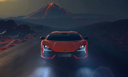 4K Ultra HD PC wallpaper featuring a sleek Lamborghini Revuelto driving on a dark road with a glowing volcanic mountain in the background.